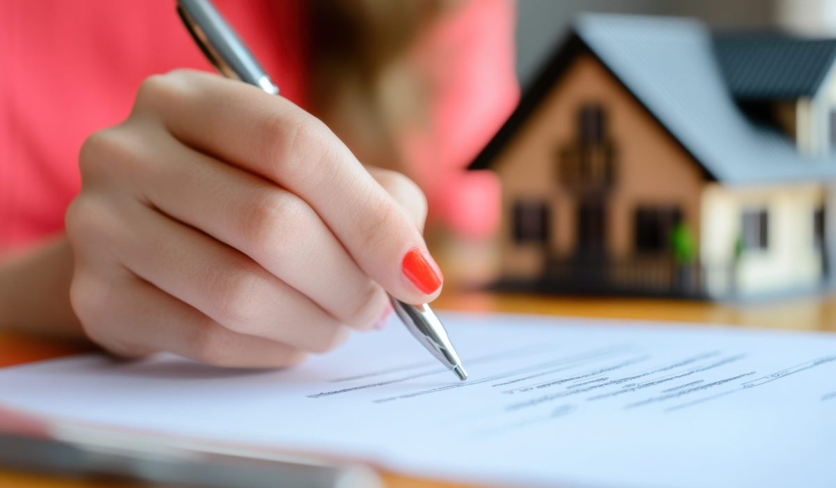 Real Estate Agent Signing Contract with Buyer